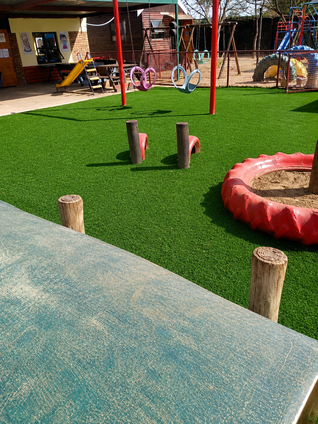 colorful preschool playground on sunny turf